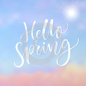Hello Spring. Inspirational saying at blue sky background with cloud. Spring season greeting.