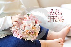 Hello Spring message with toddler boy with flowers
