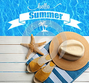 Hello Summer. Beach accessories on white wooden deck near swimming pool, flat lay