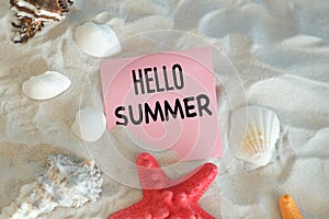 Hello Summer. Beautiful starfish and seashells on sandy beach.