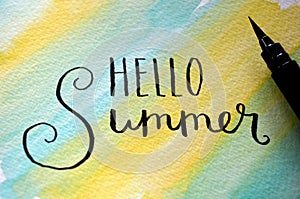 `HELLO SUMMER` hand-lettered on summery watercolor background