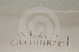 Hello Summer inscription on sand beach background. Sunny beach sand message with sea wave.