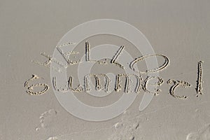 Hello Summer inscription on sand beach. Sunny beach sand message. Hello Summer lettering.
