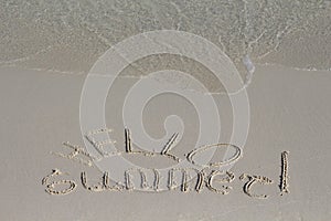 Hello Summer inscription on sand beach. Sunny beach sand message with sea wave. Hello Summer lettering.