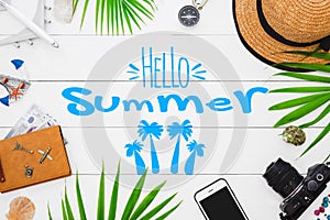 Hello Summer, Summertime travel and vacation background concept. Flat lay traveler accessories on white wooden background with