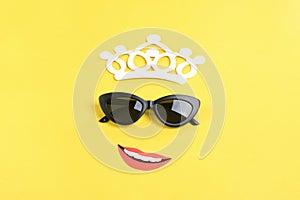 Hello summer The sun with stylish black sunglasses, smiling mouth on yellow background