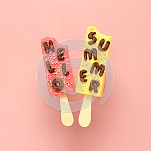 Hello Summer text and ice creams on pastel pink background