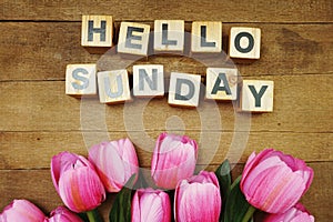 Hello Sunday alphabet letters on wooden background