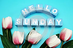 Hello sunday with blue wooden cubes alphabet letter on blue background