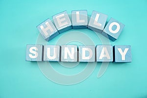 Hello sunday with blue wooden cubes alphabet letter on blue background