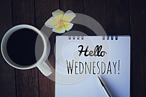Hello Wednesday. Have a happy, beautiful and productive Wednesday concept. With morning coffee and text greeting on notepad. photo