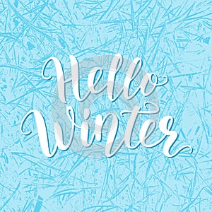 Hello winter. Blue Hand lettering quote logo with frozen texture. Brush Calligraphic design. Vector illustration.