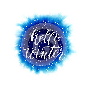 Hello winter lettering on blue watercolor splash