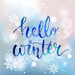 Hello winter text. Brush lettering at blue winter photo