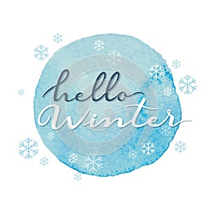 Hello winter vector handwritten calligraphy on blue round watercolour