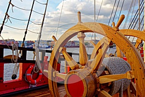 Helm wheel of an old wooden sailboat. Details of the deck of the ship