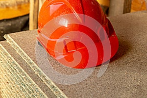 Helmet made of bright orange plastic, lightweight reliable protection of the head of the worker