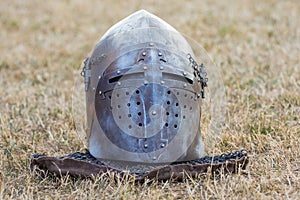 Helmet of medieval knight on grass. Knight`s armor_