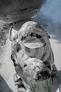 Helmet on motocycle wash with soap. Black helmet covered by foam