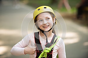 Helmet - safety equipment for Little girl playing. Helmet and safety equipment. Rope park - climbing center. Children