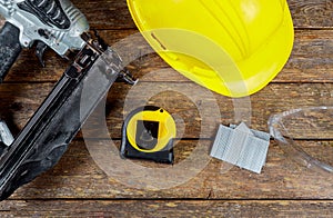 Helmet safety glasses construction and gun air nailer tool photo