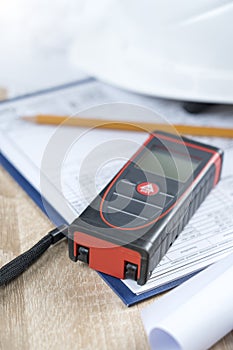 helmet and tools for construction drawings and construction drawings and laser rangefinder for distance measurements