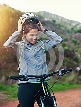 Helmet, woman and mountain bike in nature, fitness and cycling sports for adventure on path. Female person, athlete and