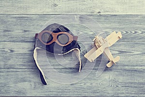 Helmet and wooden airplane. the concept of conquering the sky