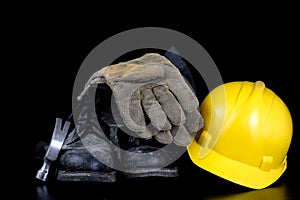 Helmet and workwear on a black working table. Accessories for co