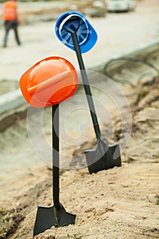 Helmets hanging on shovels