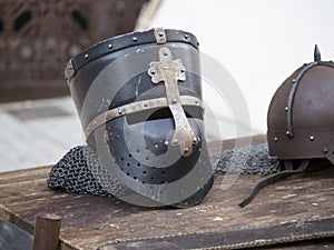 Helmets medieval of knights on a table