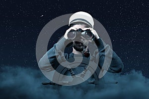Helmsman with binoculars and cap over clouds viewing to the starry sky