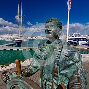 The Helmsman Statue at the Vilamoura marina waterfront, Portugal photo