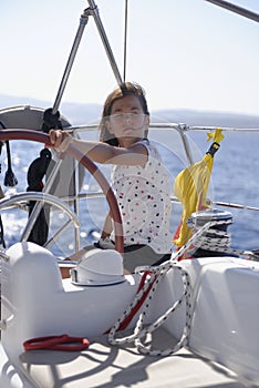 Helmsman steering sailing boat photo