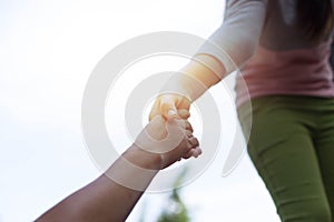 Help Concept Young girl Hands reaching out to help old