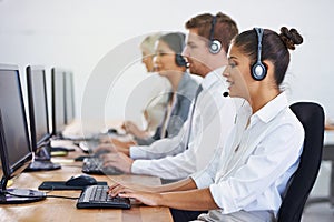 Help desk, team and phone call with women, men and typing on computer at customer support. Headset, telemarketing and