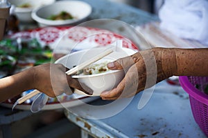 Help with feeding homeless people to alleviate hunger. poverty concept photo