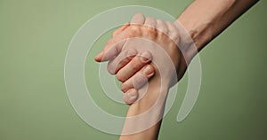 Help friend through a tough time. rescue gesture. hands reaching together on green background