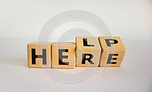 Help is here symbol. Turned cubes and changed the word help to here. Beautiful white background, copy space. Business,