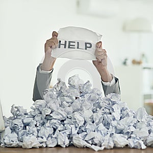 Help, Im drowning in paperwork. Shot of an unidentifiable businessman drowning under a pile of paperwork in the office.