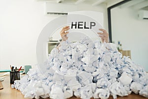 Help, Im drowning in paperwork. Shot of an unidentifiable businesswoman drowning under a pile of paperwork in the office