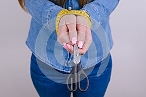 Help me please! Cropped close up photo of tired exhausted sad unhappy upset lady holding black instrument  grey background