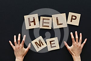 HELP ME wooden sign with woman hands over black
