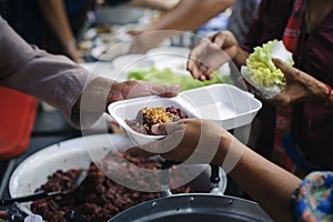 Help serving free food to the poor Needy : concept  Hunger