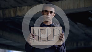 Help sign in black teenager hands, sad violence victim, human rights, bullying