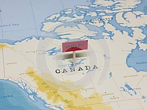 `HELP!` Sign with Pole on Canada of the World Map