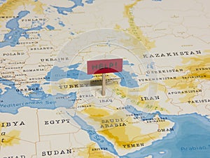 `HELP!` Sign with Pole on Iraq of the World Map