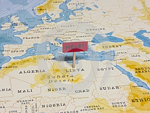 `HELP!` Sign with Pole on Libya of the World Map