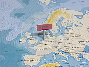 `HELP!` Sign with Pole on Netherlands of the World Map