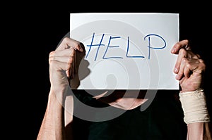 Help. Suicidal depression. Man holding help sign paper